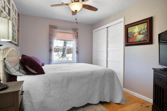 1014 Long Bow Ct, Nekoosa, WI 54457 - bedroom featuring light wood-style flooring, baseboards, a closet, and a ceiling fan