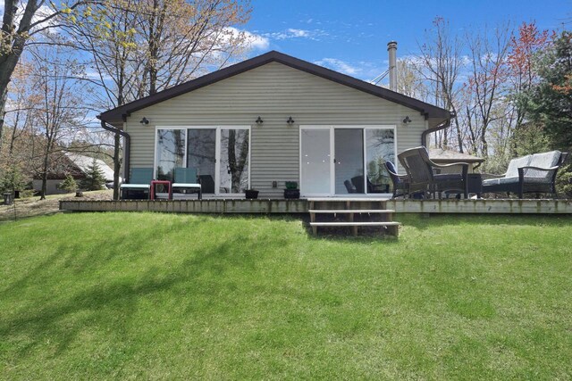 1014 Long Bow Ct, Nekoosa, WI 54457 - rear view of house with a wooden deck and a lawn