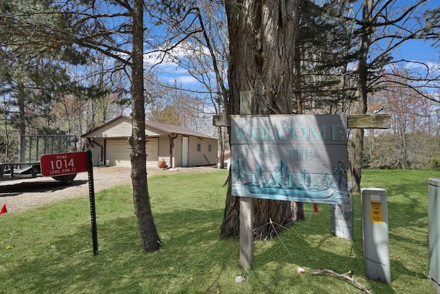 1014 Long Bow Ct, Nekoosa, WI 54457 - view of green lawn featuring a detached garage