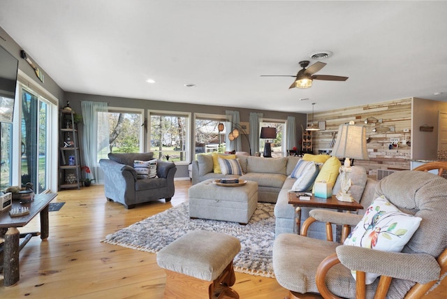 1014 Long Bow Ct, Nekoosa, WI 54457 - living area with plenty of natural light, ceiling fan, wood walls, light wood-style floors, and recessed lighting