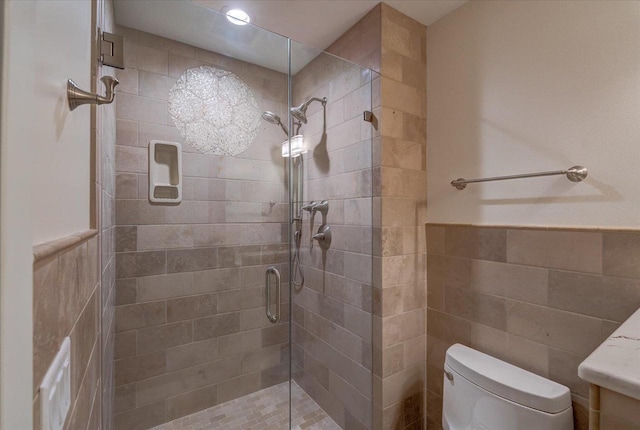 2818 Marshall Ct, Madison, WI 53705 - bathroom with a tile shower, toilet, tile walls, a wainscoted wall, and recessed lighting