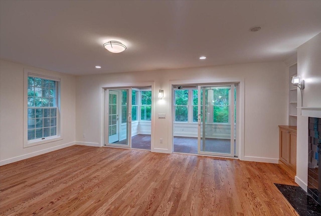 2818 Marshall Ct, Madison, WI 53705 - unfurnished living room featuring baseboards, light wood-type flooring, a fireplace, and recessed lighting