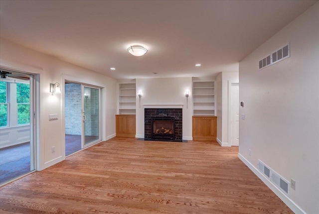 2818 Marshall Ct, Madison, WI 53705 - unfurnished living room with a fireplace with flush hearth, built in features, light wood-style floors, baseboards, and recessed lighting