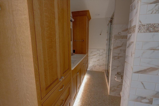 2818 Marshall Ct, Madison, WI 53705 - bathroom with a shower stall, vanity, tile walls, and wainscoting