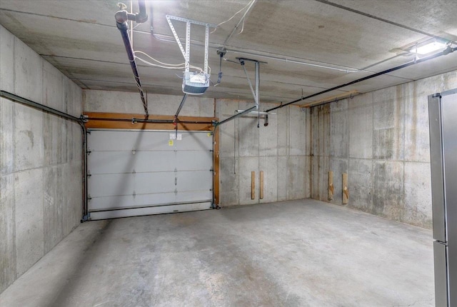 2818 Marshall Ct, Madison, WI 53705 - garage featuring a garage door opener and freestanding refrigerator
