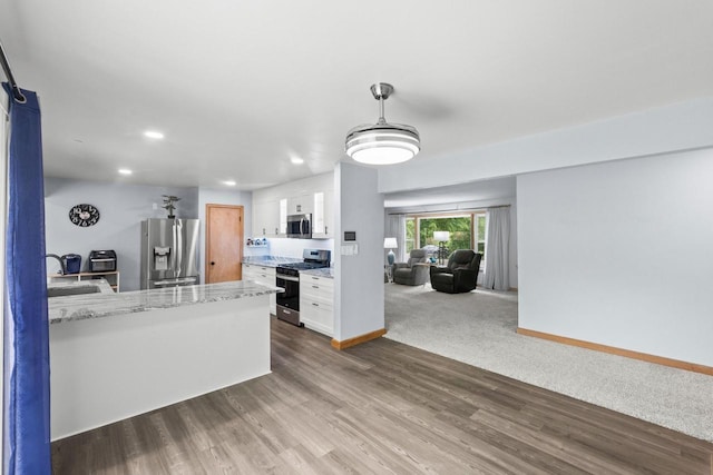519 S Charles St, Waukesha, WI 53186 - kitchen featuring stainless steel appliances, white cabinets, baseboards, recessed lighting, and a peninsula