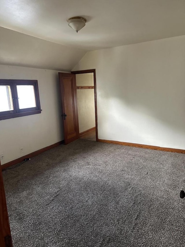 3747 N Vel R Phillips Ave, Milwaukee, WI 53212 - unfurnished room featuring carpet floors, lofted ceiling, and baseboards