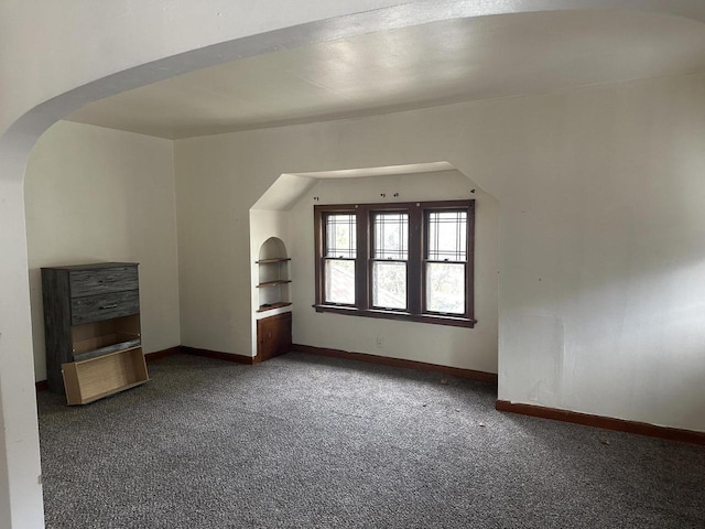 3747 N Vel R Phillips Ave, Milwaukee, WI 53212 - additional living space featuring carpet floors, arched walkways, and baseboards