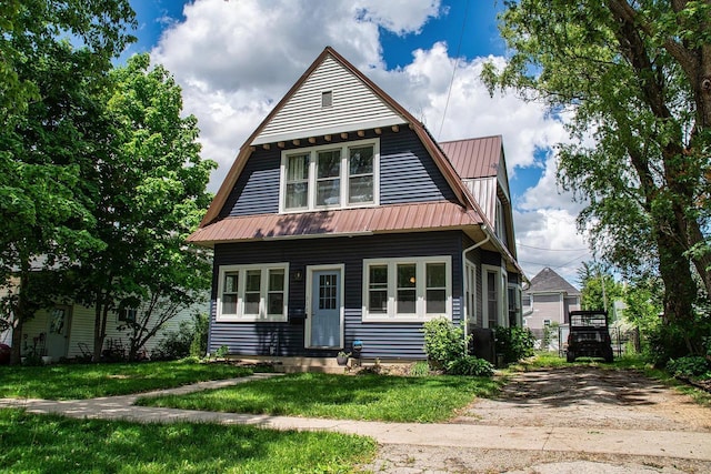 318 E Mary St, Darlington, WI 53530 - view of front facade with metal roof, a front yard, a gambrel roof, and entry steps