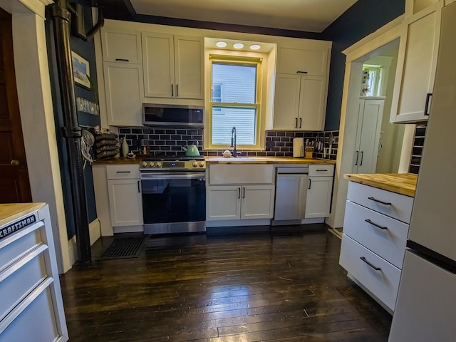 318 E Mary St, Darlington, WI 53530 - kitchen with wood counters, stainless steel appliances, dark wood-type flooring, and white cabinets