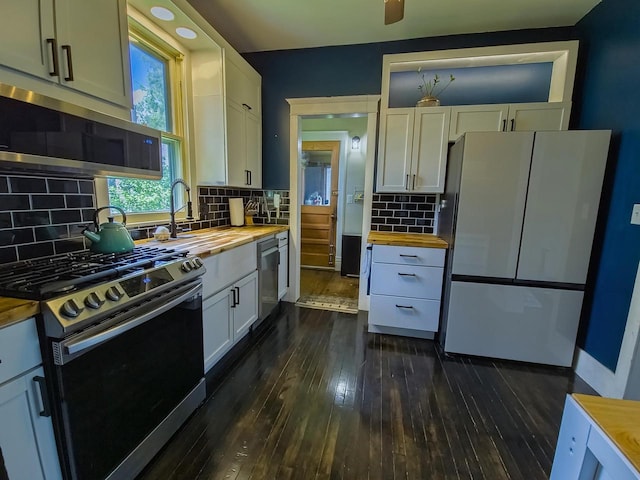 318 E Mary St, Darlington, WI 53530 - kitchen featuring wood counters, appliances with stainless steel finishes, dark wood-style floors, backsplash, and white cabinets