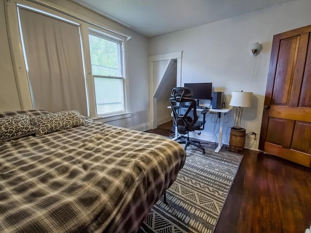 318 E Mary St, Darlington, WI 53530 - bedroom with dark wood-style flooring and baseboards