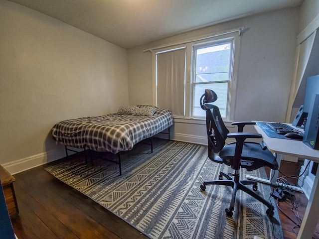 318 E Mary St, Darlington, WI 53530 - bedroom featuring baseboards, wood finished floors, and a desk