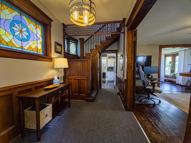318 E Mary St, Darlington, WI 53530 - hall with an office area, a chandelier, a wainscoted wall, stairs, and wood finished floors