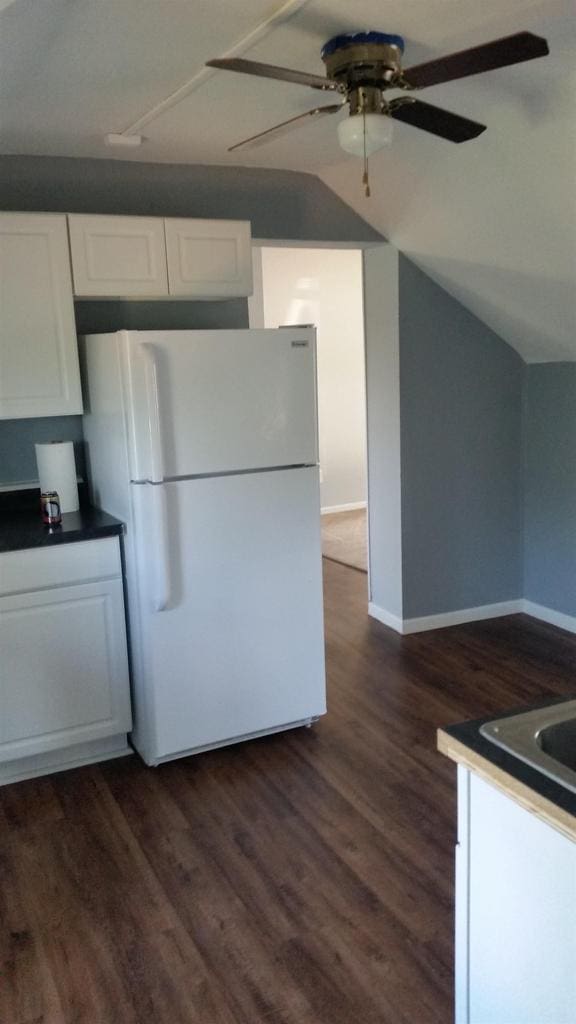 506 E Cook St, Portage, WI 53901 - kitchen with freestanding refrigerator, white cabinetry, ceiling fan, baseboards, and lofted ceiling