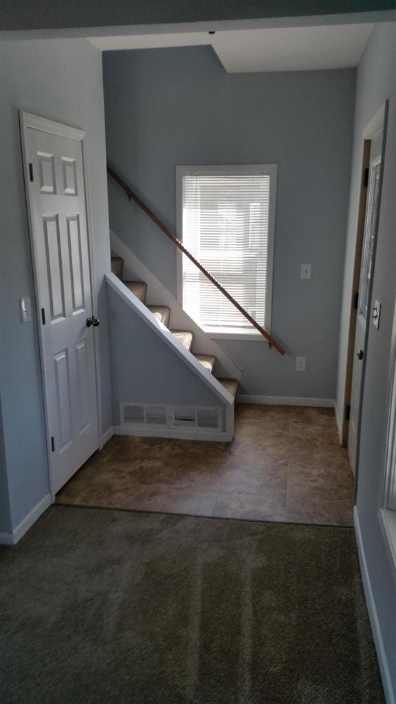 506 E Cook St, Portage, WI 53901 - staircase featuring carpet, baseboards, and tile patterned flooring