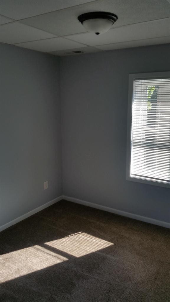 506 E Cook St, Portage, WI 53901 - empty room featuring dark carpet and baseboards