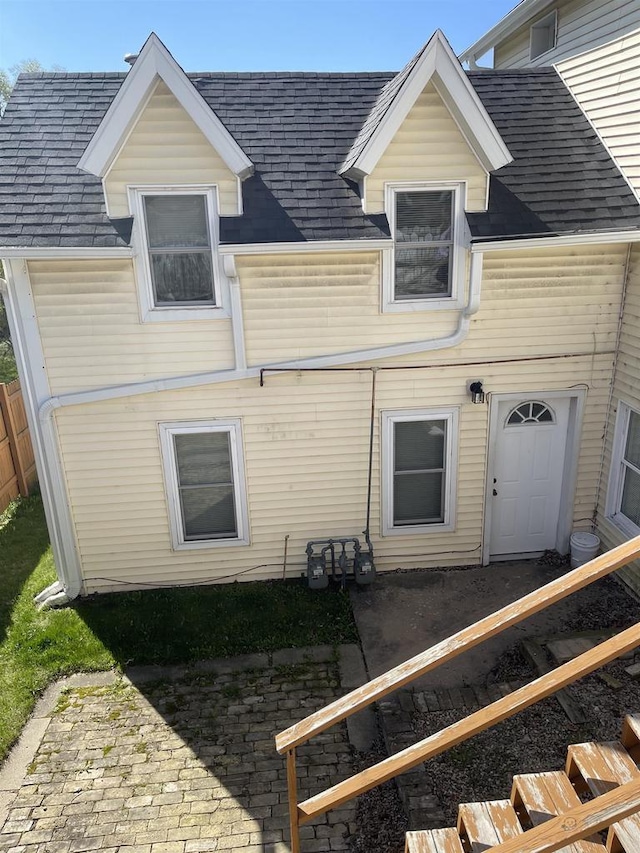 506 E Cook St, Portage, WI 53901 - back of house featuring a shingled roof and a patio