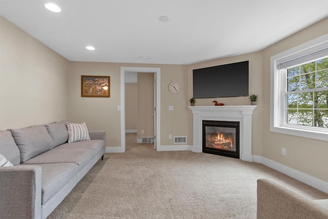 3155 W Lake Helen Dr, Rosholt, WI 54473 - living area featuring a glass covered fireplace, light carpet, baseboards, and recessed lighting