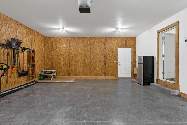 3155 W Lake Helen Dr, Rosholt, WI 54473 - garage with freestanding refrigerator and a garage door opener