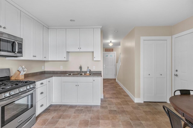 3155 W Lake Helen Dr, Rosholt, WI 54473 - kitchen with appliances with stainless steel finishes, a sink, white cabinets, and dark countertops