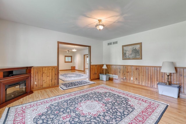 W1041 County Road O, Oconomowoc, WI 53066 - living area with a wainscoted wall, wood finished floors, and wood walls
