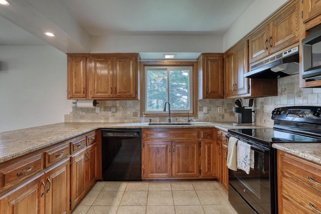 W1041 County Road O, Oconomowoc, WI 53066 - kitchen featuring black appliances, under cabinet range hood, a sink, brown cabinets, and recessed lighting