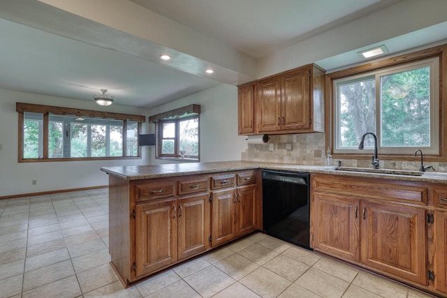W1041 County Road O, Oconomowoc, WI 53066 - kitchen featuring black dishwasher, brown cabinetry, a sink, light tile patterned floors, and a peninsula