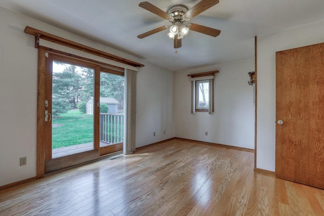 W1041 County Road O, Oconomowoc, WI 53066 - empty room with light wood finished floors, ceiling fan, and baseboards