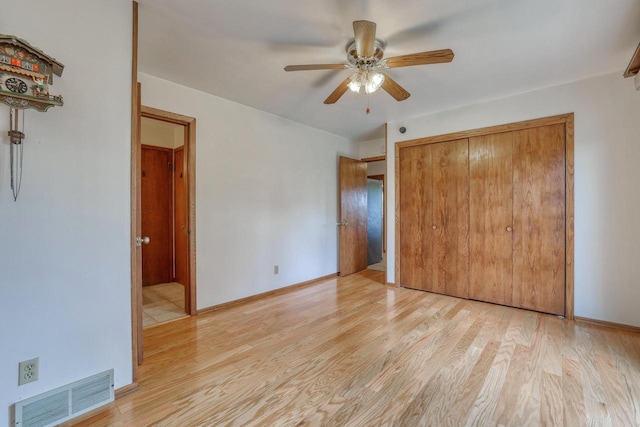 W1041 County Road O, Oconomowoc, WI 53066 - unfurnished bedroom featuring light wood-style floors, a closet, a ceiling fan, and baseboards