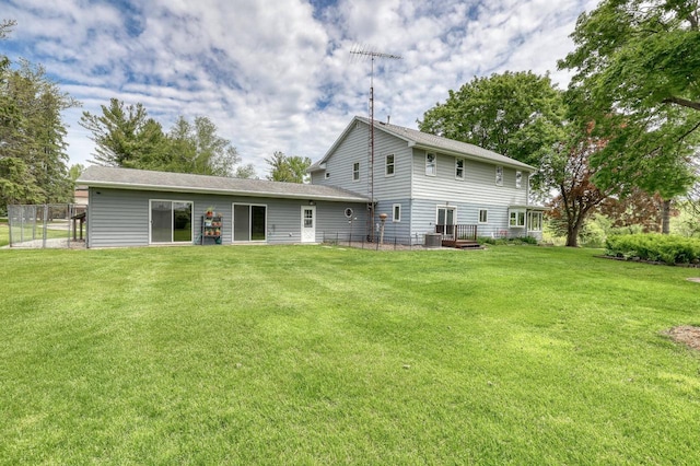 W1041 County Road O, Oconomowoc, WI 53066 - rear view of house with a lawn and central AC unit