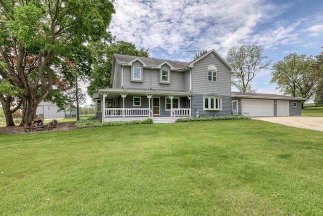 W1041 County Road O, Oconomowoc, WI 53066 - view of front of home with covered porch, concrete driveway, a front lawn, and an attached garage