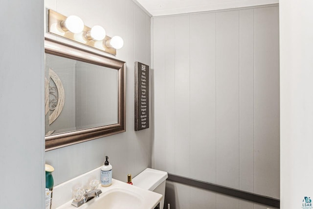 708 2nd Ave W, Ashland, WI 54806 - half bathroom featuring toilet and a sink