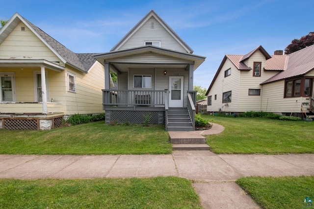 708 2nd Ave W, Ashland, WI 54806 - shotgun-style home with a porch and a front lawn
