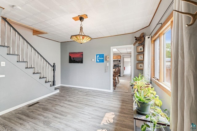 708 2nd Ave W, Ashland, WI 54806 - foyer entrance featuring wood finished floors, stairs, and baseboards