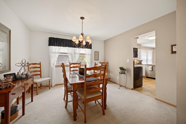 417 Raintree Dr, Fort Atkinson, WI 53538 - dining space featuring a chandelier and light colored carpet
