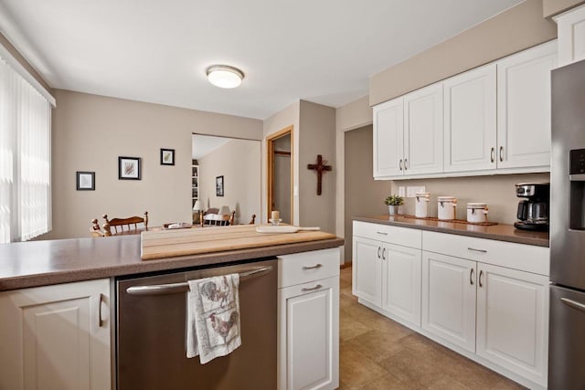 417 Raintree Dr, Fort Atkinson, WI 53538 - kitchen with appliances with stainless steel finishes, white cabinets, dark countertops, and light flooring