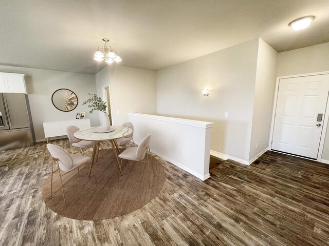 620 E Maple Beach Dr, Edgerton, WI 53534 - dining space featuring dark wood-type flooring, a chandelier, and baseboards