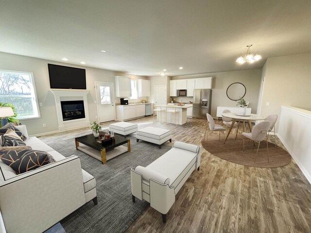 620 E Maple Beach Dr, Edgerton, WI 53534 - living room with wood finished floors, a chandelier, plenty of natural light, and recessed lighting