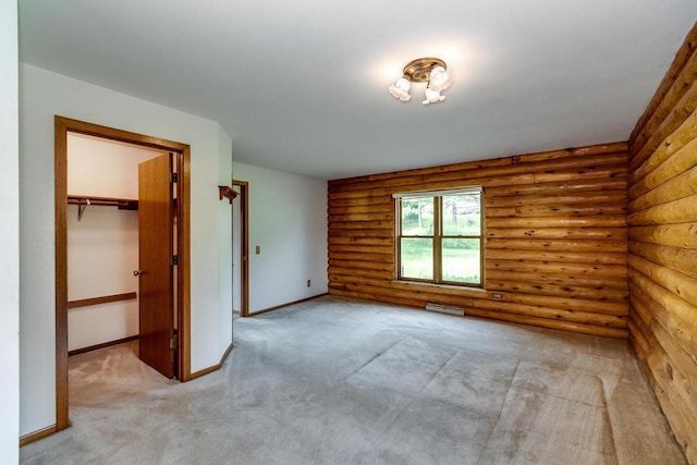 4884 Brewery Rd, Cross Plains, WI 53528 - carpeted empty room with log walls and baseboards