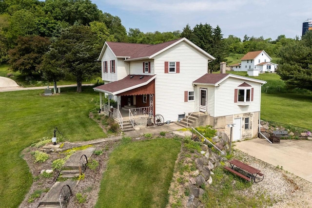 4884 Brewery Rd, Cross Plains, WI 53528 - back of house with covered porch, a yard, and roof with shingles