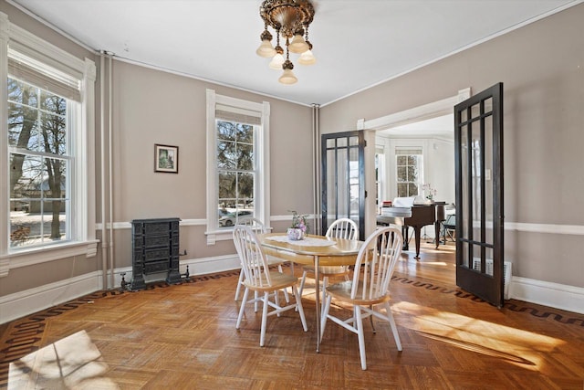 1105 N 6th St, Sheboygan, WI 53081 - dining space featuring healthy amount of natural light, ornamental molding, baseboards, and a chandelier