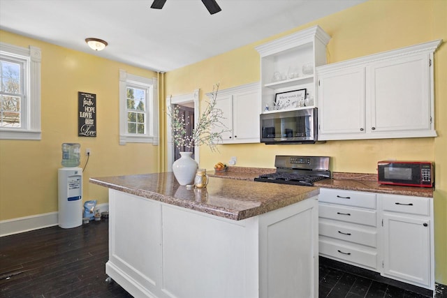 1105 N 6th St, Sheboygan, WI 53081 - kitchen featuring range, black microwave, open shelves, and white cabinetry