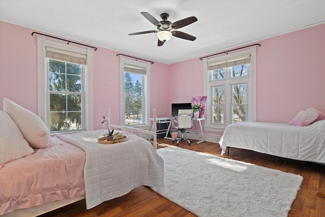 1105 N 6th St, Sheboygan, WI 53081 - bedroom with multiple windows, wood finished floors, and a desk
