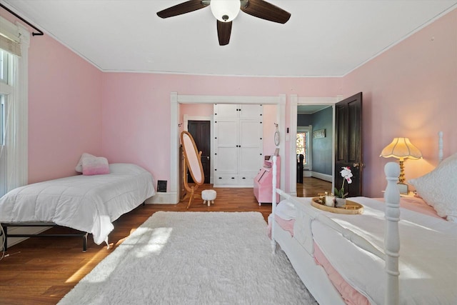 1105 N 6th St, Sheboygan, WI 53081 - bedroom with wood finished floors, multiple windows, and ceiling fan