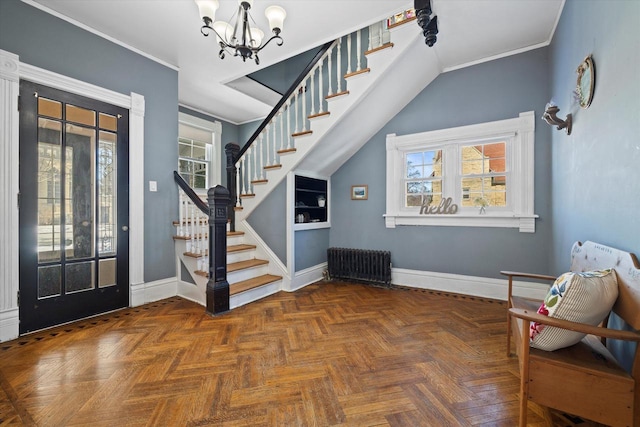 1105 N 6th St, Sheboygan, WI 53081 - foyer entrance featuring radiator heating unit, stairs, a chandelier, baseboards, and crown molding