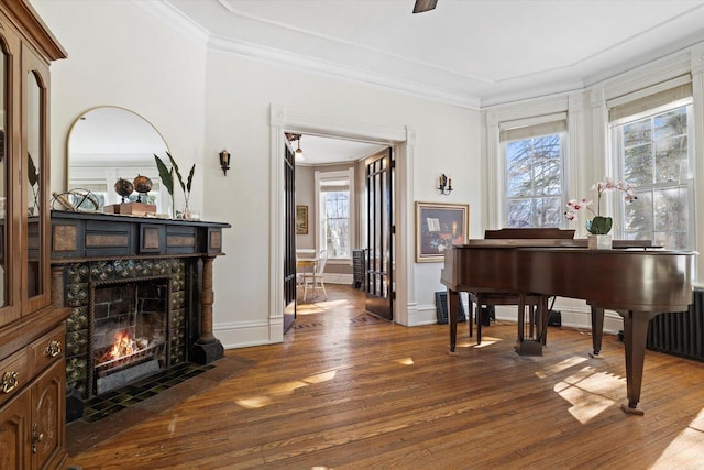 1105 N 6th St, Sheboygan, WI 53081 - living area with wood finished floors, a tiled fireplace, healthy amount of natural light, ornamental molding, and baseboards