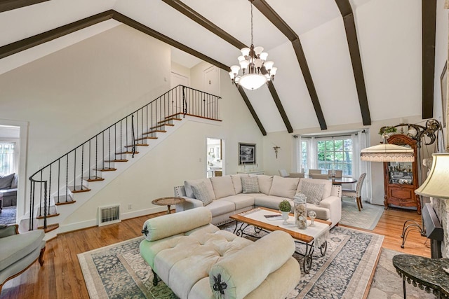 933 Juneau Dr, Fontana, WI 53125 - living room featuring high vaulted ceiling, stairway, beam ceiling, a chandelier, and light wood-type flooring