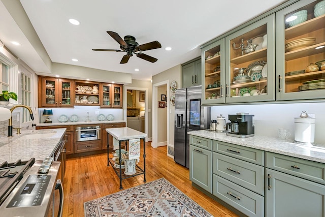 933 Juneau Dr, Fontana, WI 53125 - kitchen with green cabinetry, a sink, stainless steel appliances, a ceiling fan, and recessed lighting