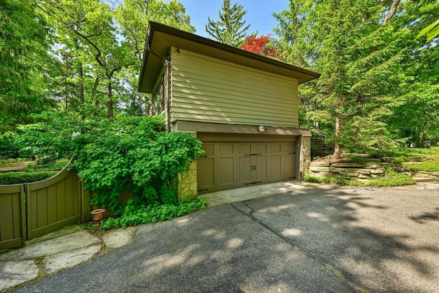 933 Juneau Dr, Fontana, WI 53125 - view of home's exterior featuring stone siding and driveway